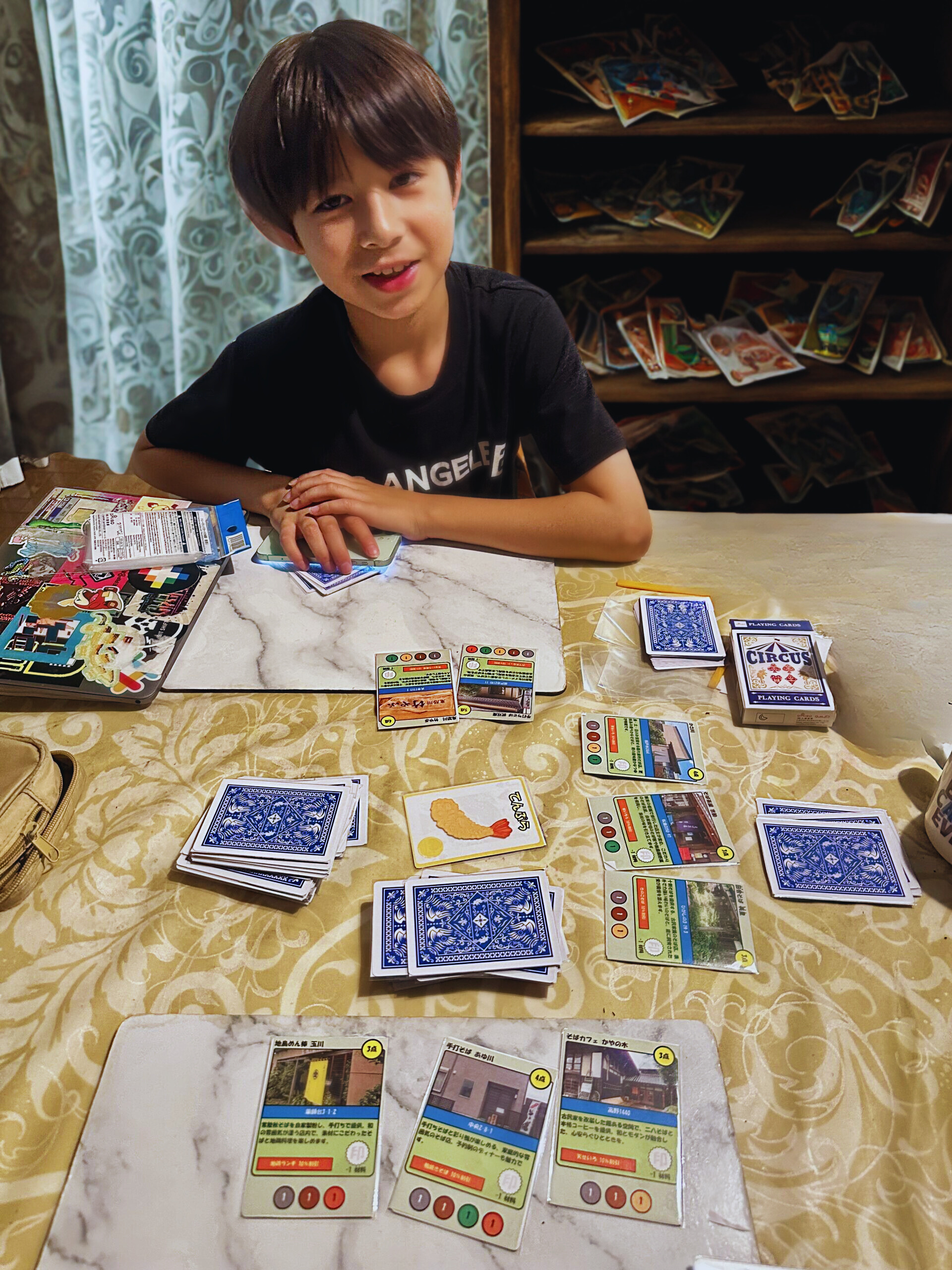 An AI-adjusted image of my son playing the card game that we created. AI edits were done to remove sensitive, personal information.